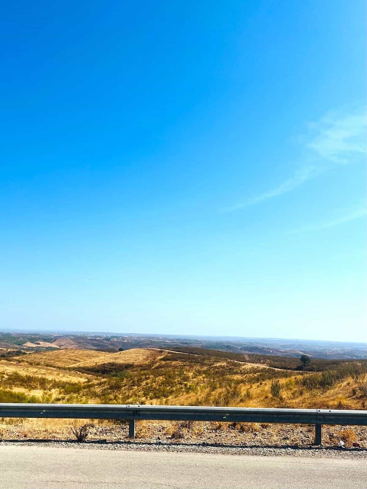 Panoramic view of rolling hills and open skies during a scenic bike ride from Café Velo.